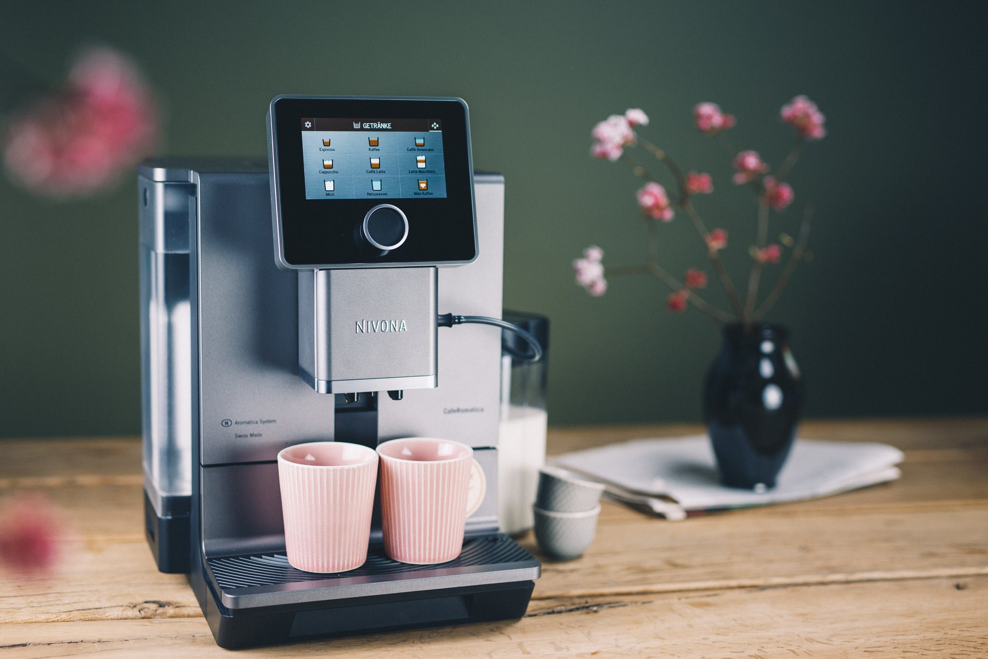 Close-up of Nivona NICR 970 dispensing espresso into a cup, highlighting adjustable coffee spout
