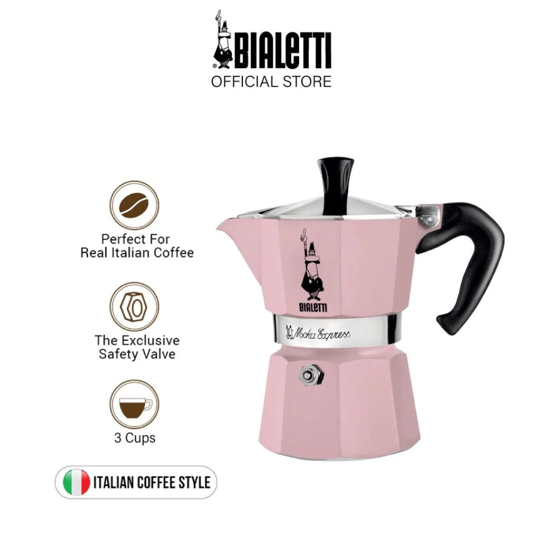 Bialetti Moka Express Pink placed on kitchen countertop beside coffee cups and beans​