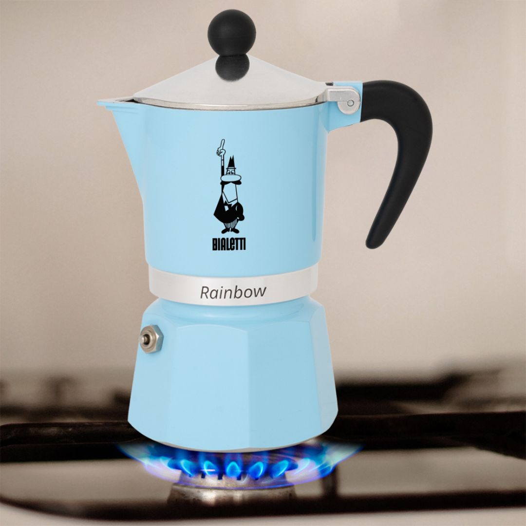 Bialetti Rainbow Blue Moka Pot placed on kitchen countertop beside coffee cups and beans​