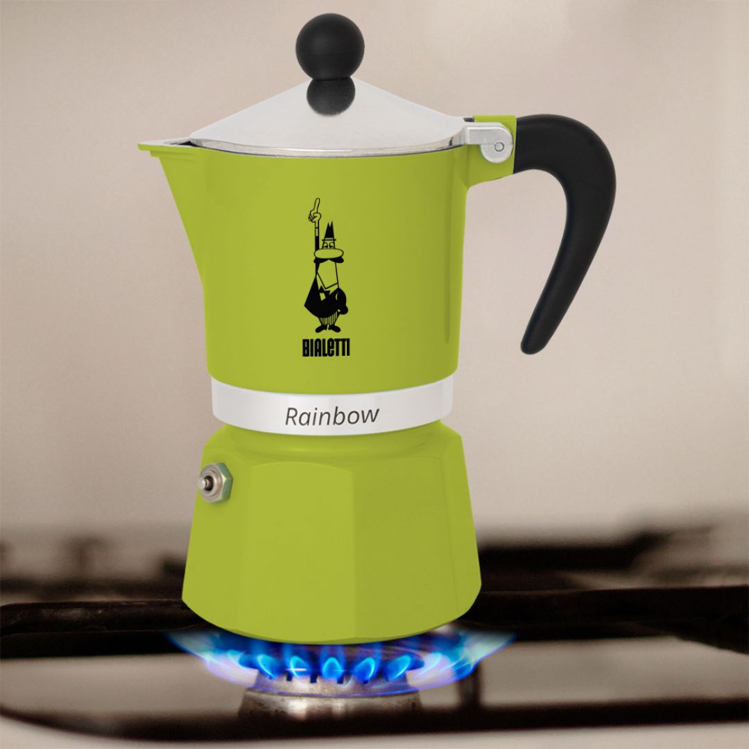 Bialetti Rainbow Green Moka Pot placed on kitchen countertop beside coffee cups and beans​