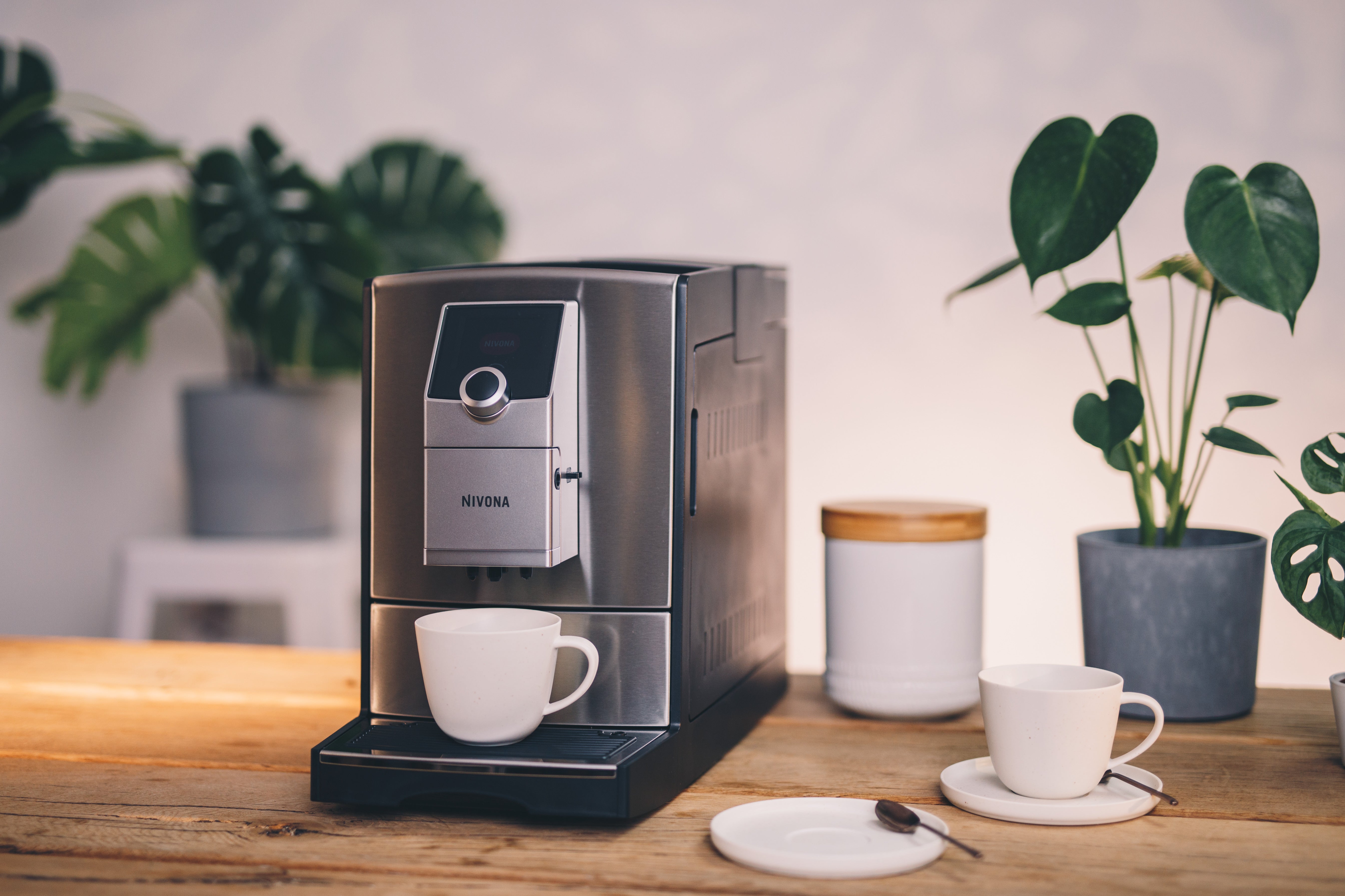 Nivona NICR 799 CafeRomatica placed on kitchen countertop – brewing espresso with cup lighting feature