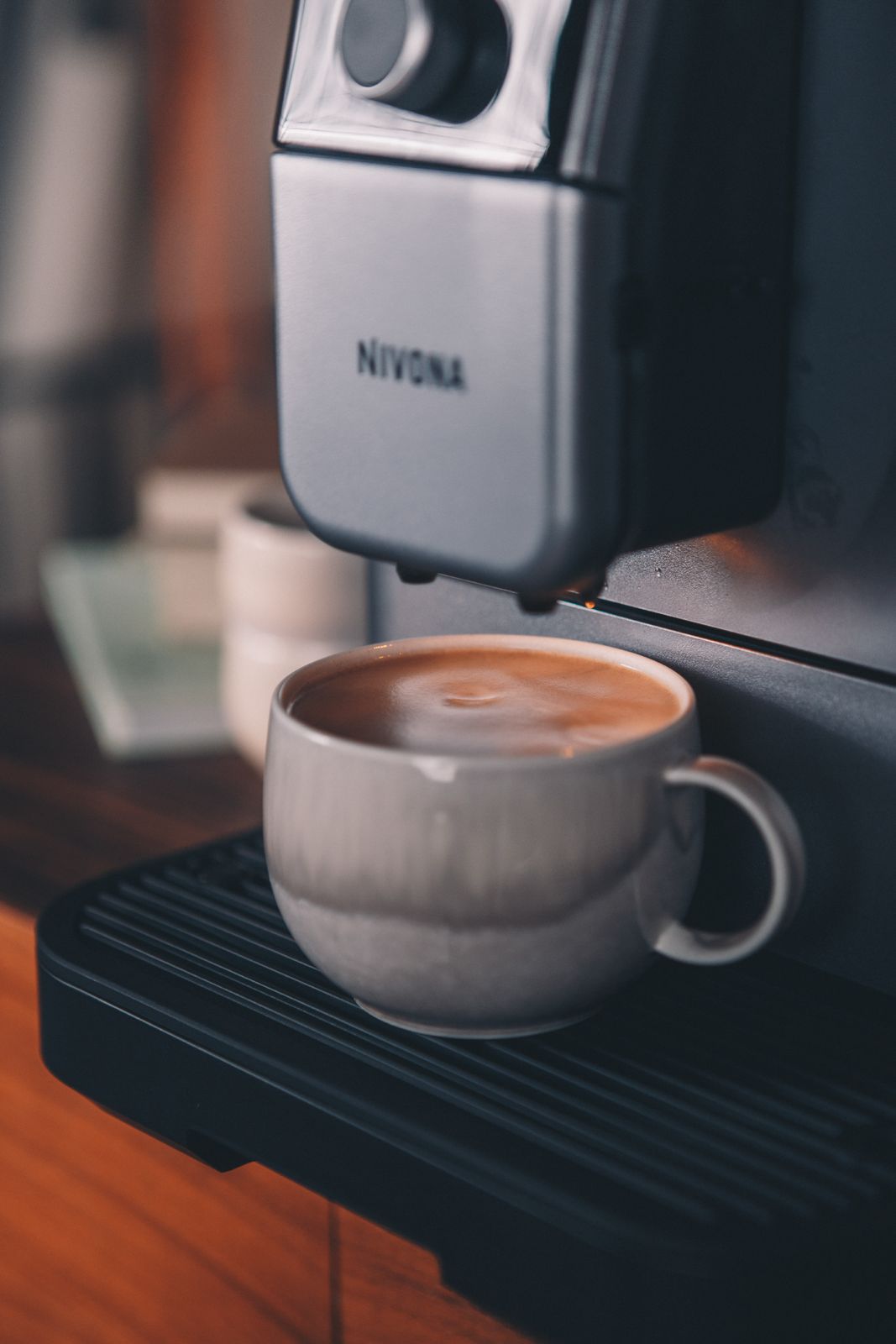 Rear view of Nivona 8107 featuring convenient rear rollers for easy movement​