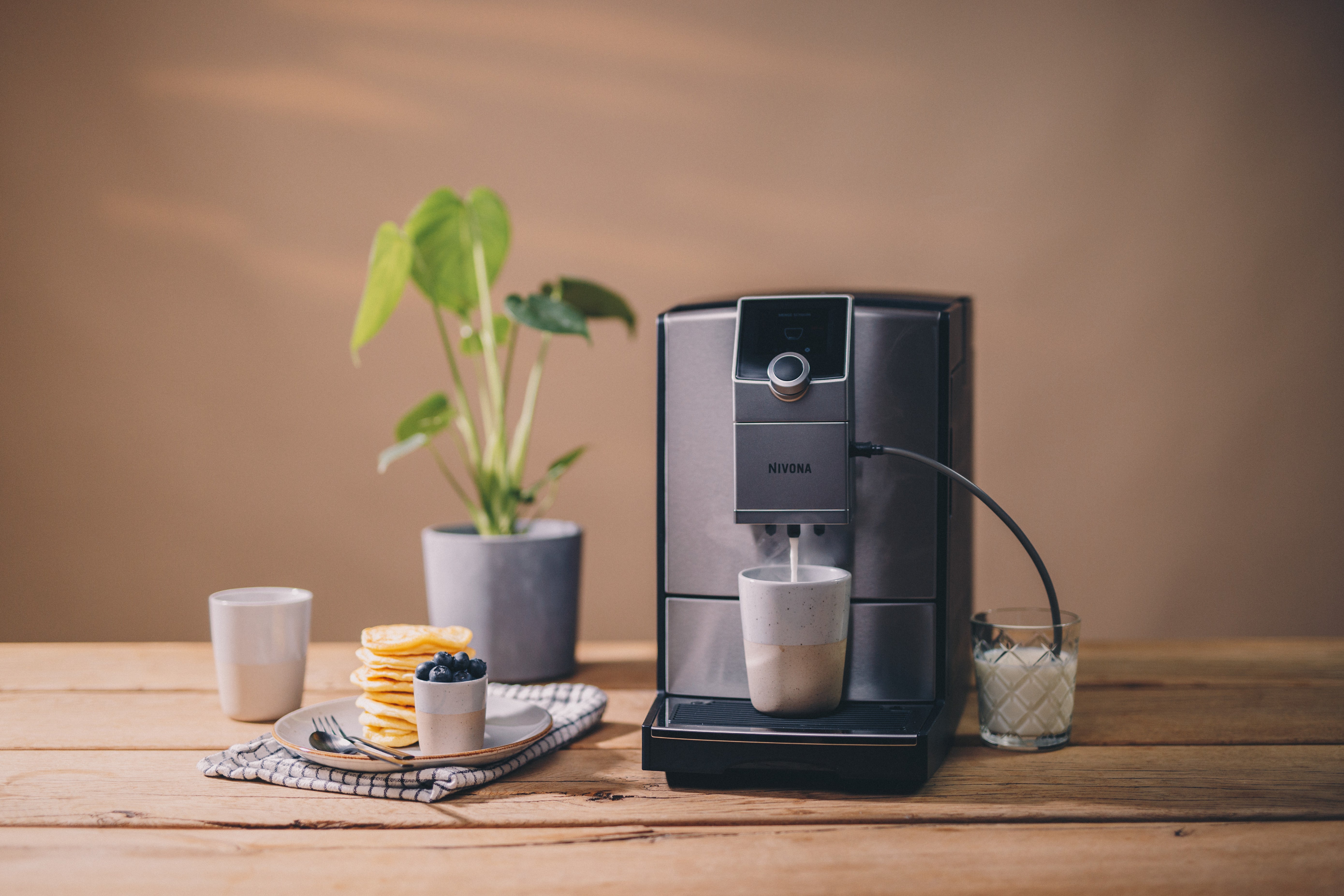 Side view of Nivona NICR 799 featuring 250g bean container and 2.2L removable water tank