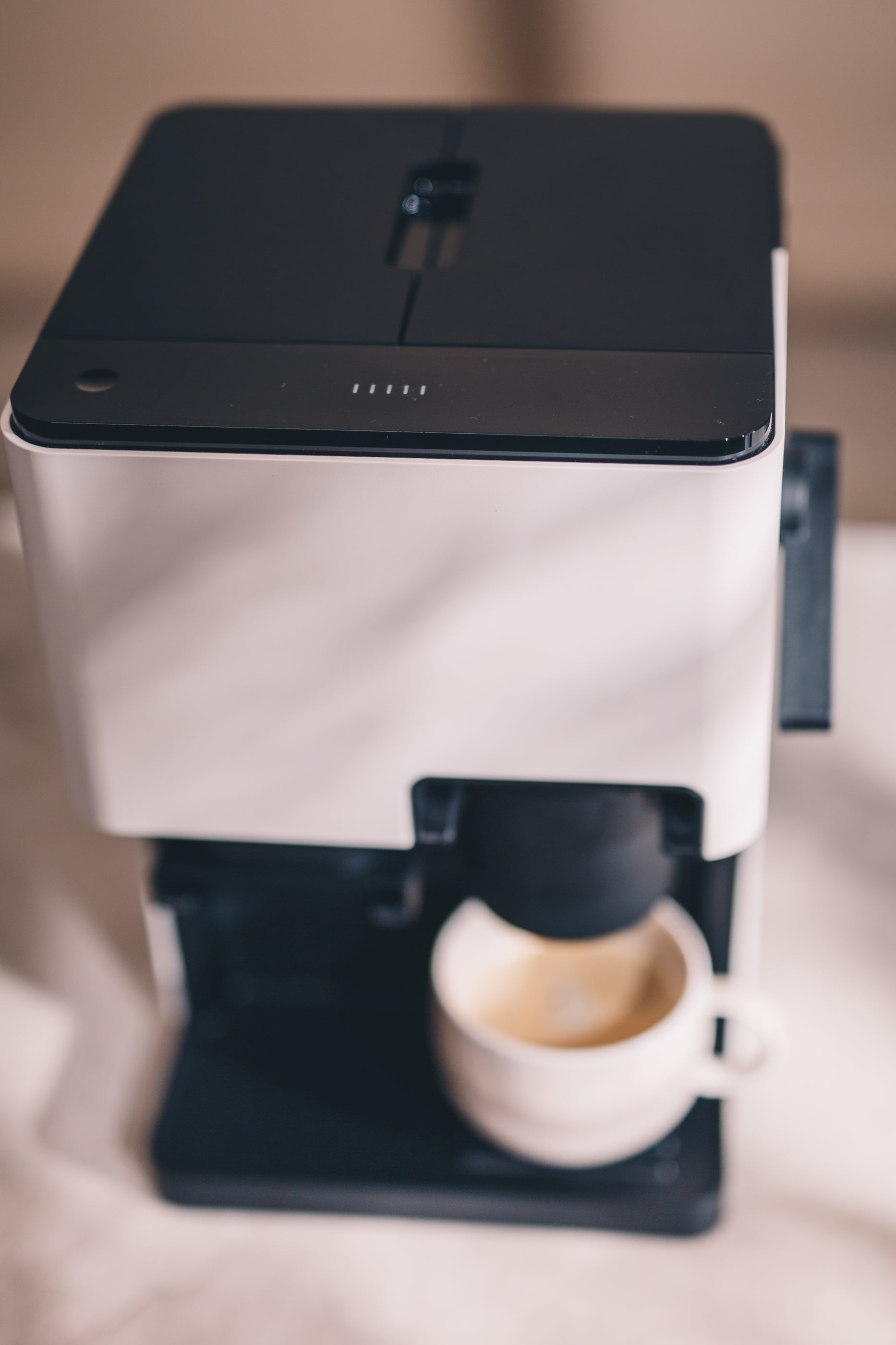 Top view of Nivona CUBE 4102 featuring 250g bean hopper and 1.4L removable water tank